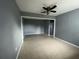 Spacious living room featuring neutral tile flooring, open layout, and a ceiling fan at 102 Luna Rd, Auburndale, FL 33823