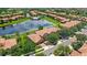 Stunning aerial view of home with a lake, community pool, and lush green landscape in a desirable neighborhood at 10308 Belfry Cir, Orlando, FL 32832