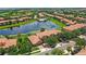 Real estate featuring an aerial view of the homes, mature landscaping, lake and community pool at 10308 Belfry Cir, Orlando, FL 32832