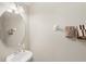 Bathroom features oval mirror, attractive light fixture and towel rack at 10308 Belfry Cir, Orlando, FL 32832