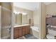 The bathroom features double sinks, a bathtub, and a glass-enclosed shower for a complete spa-like experience at 10308 Belfry Cir, Orlando, FL 32832