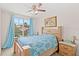 The bedroom features a decorative bed, a ceiling fan, a balcony with a view, and natural light at 10308 Belfry Cir, Orlando, FL 32832