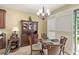 The dining area is cozy, with plantation shutters for privacy and a glass table for an elegant touch at 10308 Belfry Cir, Orlando, FL 32832
