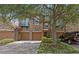 Attractive townhome exterior featuring stone accents, a private balcony, multi-car garage, and lovely tree at 10308 Belfry Cir, Orlando, FL 32832