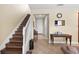 The foyer features a staircase, tile flooring, and neutral wall colors providing a bright and welcoming entrance at 10308 Belfry Cir, Orlando, FL 32832