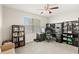 The home office features black built-in shelving, a desk, and a window offering ample natural light at 10308 Belfry Cir, Orlando, FL 32832