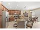 An open kitchen features stainless steel appliances, granite countertops, and breakfast bar seating at 10308 Belfry Cir, Orlando, FL 32832