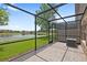 Screened lanai offers a view of the pond, with outdoor living space and brick pavers at 10308 Belfry Cir, Orlando, FL 32832
