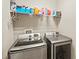 Laundry room features a side-by-side washer and dryer and wire shelving at 10308 Belfry Cir, Orlando, FL 32832