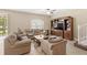 Comfortable living room with tile floors, ceiling fan, large TV, and plush, cozy seating at 10308 Belfry Cir, Orlando, FL 32832