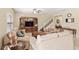 Comfortable living room featuring stairs, tile floors, a ceiling fan, and a large entertainment center at 10308 Belfry Cir, Orlando, FL 32832