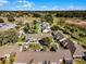 Aerial view of homes with well-kept landscaping and lush trees near a pond at 1126 Villa Ln # 91, Apopka, FL 32712