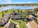 Aerial of the property showcases a picturesque lake and lush greenery, offering a serene living environment at 1126 Villa Ln # 91, Apopka, FL 32712