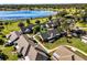 Scenic aerial view of homes with lush trees and well-kept landscaping near a pond at 1126 Villa Ln # 91, Apopka, FL 32712