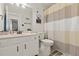 Clean bathroom featuring a vanity with sink, toilet, and shower with striped curtain at 1126 Villa Ln # 91, Apopka, FL 32712