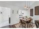 Bright dining area with modern lighting, opening to the living space and entry hall at 1126 Villa Ln # 91, Apopka, FL 32712