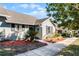 Landscaped walkway leads to a cozy home with tidy, well-maintained outdoor space at 1126 Villa Ln # 91, Apopka, FL 32712