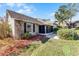 Charming exterior view of a well-maintained home with landscaped yard and screened-in patio at 1126 Villa Ln # 91, Apopka, FL 32712