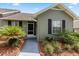 Inviting home exterior showcasing a front door, lush landscaping, and a well-manicured lawn at 1126 Villa Ln # 91, Apopka, FL 32712
