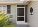 Close-up of a well-maintained front entrance with a screen door and decorative house number at 1126 Villa Ln # 91, Apopka, FL 32712