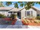 Charming home featuring manicured landscaping, stone walkway, and a screened-in front porch at 1126 Villa Ln # 91, Apopka, FL 32712