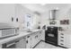 Bright kitchen with stainless appliances, white cabinetry and efficient layout at 1126 Villa Ln # 91, Apopka, FL 32712