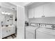 Bright laundry room featuring modern appliances, ample cabinet space, and a convenient sink area at 1126 Villa Ln # 91, Apopka, FL 32712