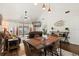 Bright open-concept living and dining area featuring vaulted ceilings and sliding glass doors to a lanai at 1126 Villa Ln # 91, Apopka, FL 32712