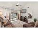 Comfortable living room with high ceilings, a ceiling fan, and sliding glass doors to the outdoor patio at 1126 Villa Ln # 91, Apopka, FL 32712