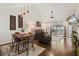 Open-concept living area with dark hardwood floors, a dining table, and sliding glass doors to a screened in porch at 1126 Villa Ln # 91, Apopka, FL 32712