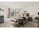 Comfortable bedroom with a large window, neutral carpet, and stylish furnishings at 1126 Villa Ln # 91, Apopka, FL 32712