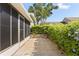 Exterior patio area showcasing paved flooring and lush, blooming bushes for added privacy at 1126 Villa Ln # 91, Apopka, FL 32712
