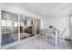 Enclosed patio with tile floor, dining table, and sliding glass doors that open to the living room at 1126 Villa Ln # 91, Apopka, FL 32712