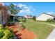 Spacious green lawn featuring mature landscaping and mulch beds under a clear blue sky at 1126 Villa Ln # 91, Apopka, FL 32712