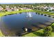 An aerial view of a pond with a fountain in a community at 1171 Lebanon Ct, Sanford, FL 32771