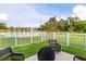 Cozy backyard seating area with a view of the pond, featuring a fire pit and comfortable wicker chairs at 1171 Lebanon Ct, Sanford, FL 32771