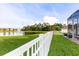 Spacious backyard with a pond view, featuring a screened enclosure and a white picket fence at 1171 Lebanon Ct, Sanford, FL 32771