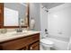 This bathroom boasts a vanity with a framed mirror, tile flooring, and a shower-tub combination at 1171 Lebanon Ct, Sanford, FL 32771