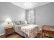 Cozy bedroom with neutral paint, plush bedding, and a view of the neighborhood at 1171 Lebanon Ct, Sanford, FL 32771