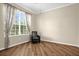 This bedroom has neutral walls, hardwood floors, a ceiling fan, and a large window at 1171 Lebanon Ct, Sanford, FL 32771
