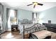 This bedroom has hardwood floors, neutral-colored walls, windows on two walls, and a ceiling fan at 1171 Lebanon Ct, Sanford, FL 32771
