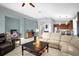 Open concept living space with tile floors, large sofa, and seamless connection to the kitchen at 1171 Lebanon Ct, Sanford, FL 32771