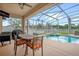 Covered patio with a dining set, grill, and a view of the pool and backyard at 1171 Lebanon Ct, Sanford, FL 32771