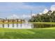 Scenic view of the community pond with a fountain, surrounded by lush landscaping and neighborhood homes at 1171 Lebanon Ct, Sanford, FL 32771