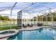 Relaxing pool with hot tub, screened enclosure, lounge chairs, and a scenic view of the backyard pond at 1171 Lebanon Ct, Sanford, FL 32771