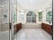 The primary bathroom has dual sinks, a soaking tub, and large window at 140 Seville Chase Dr, Winter Springs, FL 32708