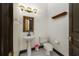 Charming powder room with pedestal sink, and classic mirror and lighting fixtures at 140 Seville Chase Dr, Winter Springs, FL 32708