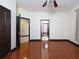 Spacious bedroom with hardwood floors and multiple doorways, offering easy access to other areas at 140 Seville Chase Dr, Winter Springs, FL 32708