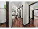 Hallway features hardwood floors, closet with sliding mirror doors, and access to multiple rooms at 140 Seville Chase Dr, Winter Springs, FL 32708