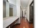 Long hallway featuring hardwood floors, built-in vanity, and neutral paint at 140 Seville Chase Dr, Winter Springs, FL 32708